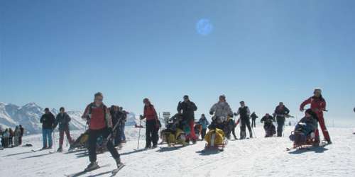 Adaptive skiing - a group of sit skiers and assistants